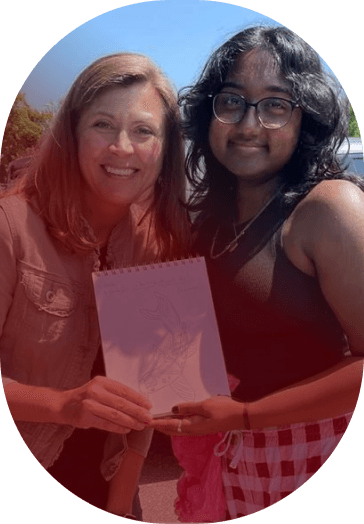 two women holding a drawing